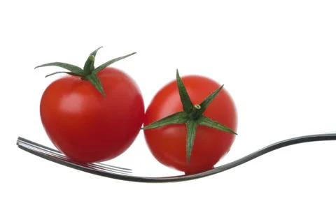Two cherry tomatoes on a fork Stock Photos