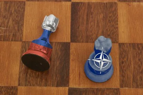 Two chess figures - showing confrontation between Russia and NATO Stock Photos