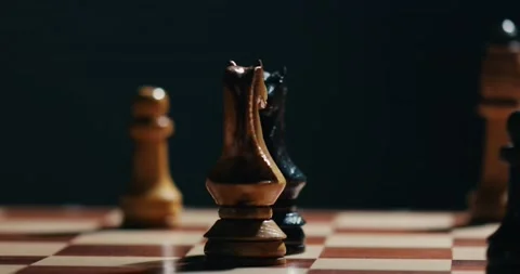 Two Chess knight and other figures spread on the chess board 4K video Stock Footage 131135404