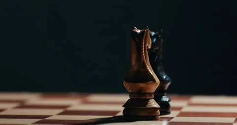 Two Chess knight figures spread on the chess board 4K video Stock Footage 131134843