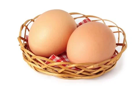 Two chicken brown eggs in a small basket. Stock Photos