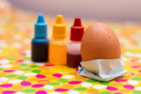 Two chicken eggs on a multi colored vibrant custom background. Red yellow and Stock Photos