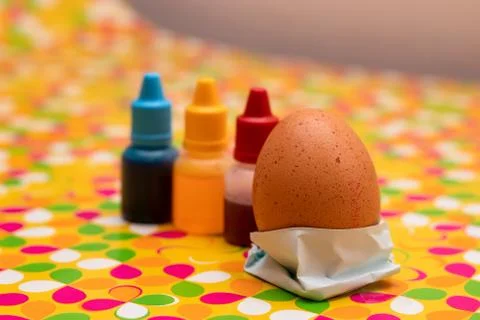 Two chicken eggs on a multi colored vibrant custom background. Red yellow and Stock Photos