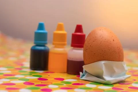 Two chicken eggs on a multi colored vibrant custom background. Red yellow and Stock Photos