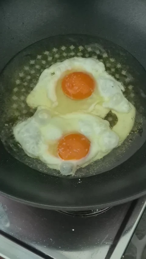 Two chicken eggs in a pan Stock Footage 314811823