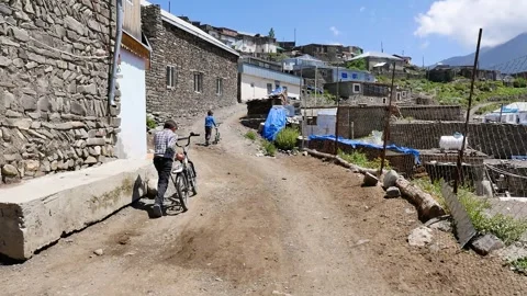 Two child drive bycicle in Khinalig village in Azerbaijan 2 Stock Footage 249171845