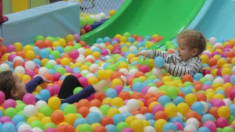 Two children are playing with colored balls Stock Footage 71834341