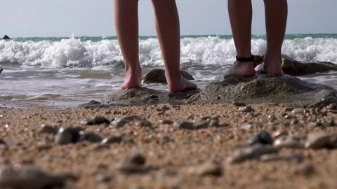 Two children are standing on the beach The water covers the feet 스톡 동영상 208038769