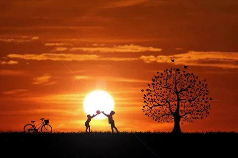 Two children are throwing balls in the meadow happily. Children's happiness c Stock Photos