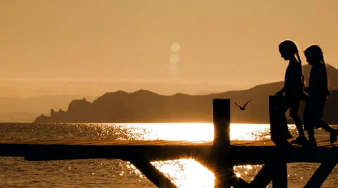 Two Children Dancing On Bridge At Sunset Stock Footage 47570930