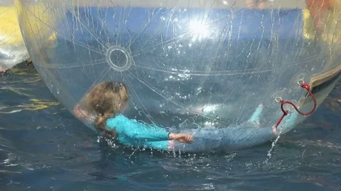 Two children flounder inside inflatable ... | Stock Video | Pond5