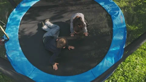 Two children have fun jumping on a trampoline Video stock 194547226
