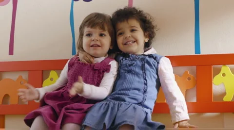 Two children hugging and playing in kindergarten Stock Footage 2298452