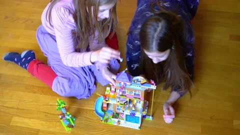 Two children playing with blocks on the floor at home. Children playing with Stock Footage 151103615