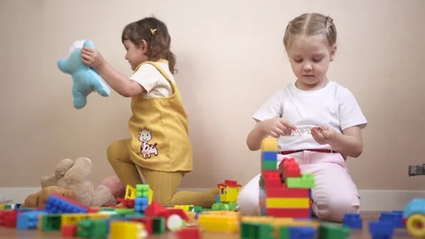 Two children playing with blocks. Group of children playing lifestyle with toys Video stock 316603714