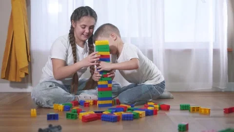 Two children playing with blocks. A group of children lifestyle are assembling a Video stock 316608686