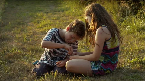 Two children playing by field in the sunset Stock Footage 133336371