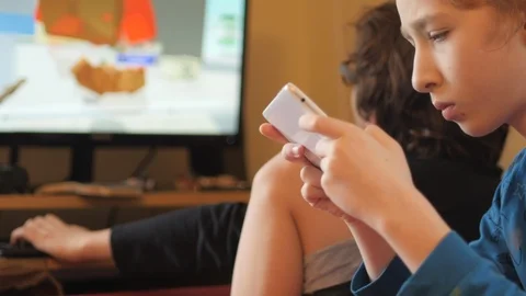 Two children playing games on tablet and computer. Video stock 122082378