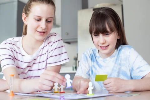 Two Children Playing Generic Board Game At Home Together Stock Photos
