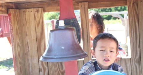 Two children playing with playground equipment 스톡 동영상 161970214