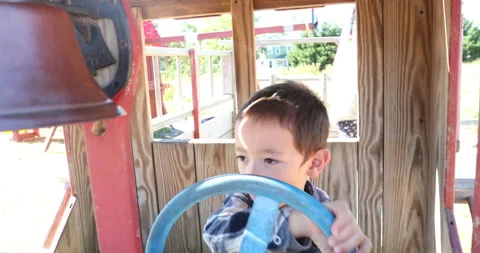 Two children playing with playground equipment 스톡 동영상 161970430