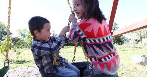Two children playing with playground equipment Stock-Footage 161970523
