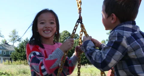 Two children playing with playground equipment Video stock 161970755