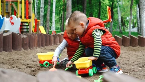Two children playing in sandbox Stock Footage 91341730