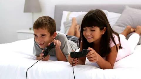 Two children playing video games Stock Footage 24771876