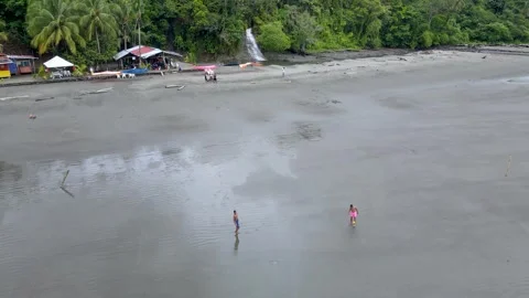 Two children playing on the wet beach in Buenaventura Stock Footage 330278426