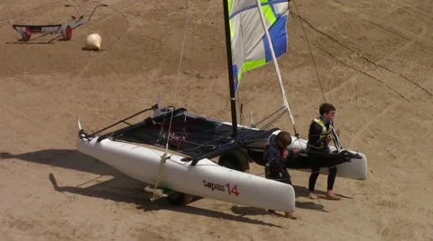 Two children pull a small catamaran Stock Footage 66564484