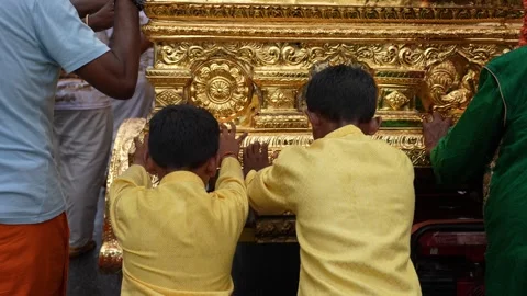 Two children push the chariot during Thaipusam Video stock 318261343