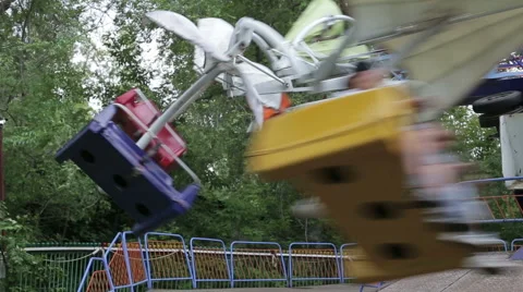 Two children ride on the carousel in an amusement park Stock Footage 64949191