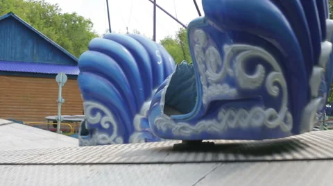 Two children ride on the carousel in an amusement park Stock Footage 65018569