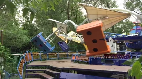 Two children ride on the carousel in an amusement park, slow mo Stock Footage 65072050