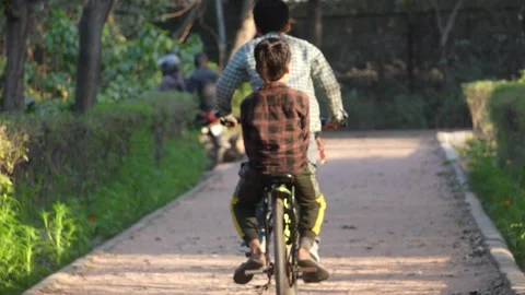 Two Children Riding Bicycle Together  Childhood Friendship and Bonding Concep Stock Footage 331145909