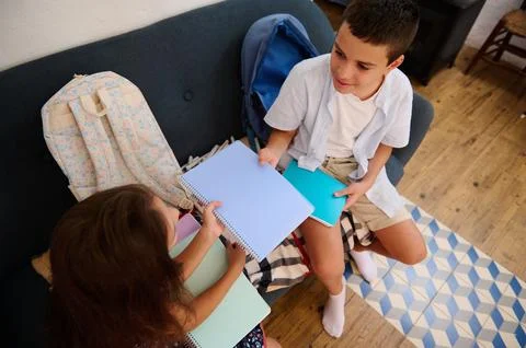 Two Children Sharing Notebooks Stock Photos