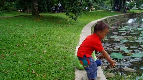 Two Children at The Side of a Pond Video stock 10678351