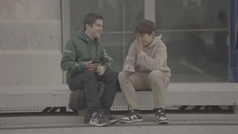 Two children sitting on the sidewalk in Madrid, Spain Stock-Footage 345027892
