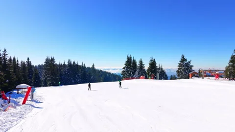 Two children skiing on mountain summit plateau, Bulgaria 스톡 동영상 346390642