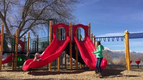 Two children slide at a playground HD Stock-Footage 73709918