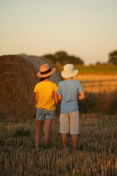Two children stand backwards, their clothes symbolizing the flag of Ukraine Stock Photos