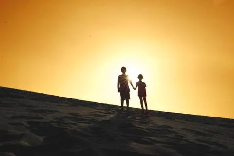 Two children standing on the dune Stockfoto's