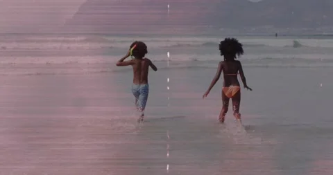 Two children stepping into shallow surf and running, animated splashes Stock Footage 330893812