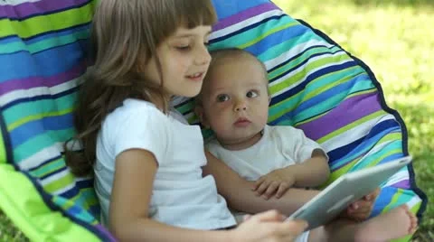 Two children with a Tablet PC outdoors Stock Footage 11453276