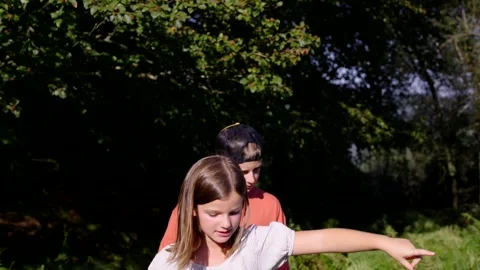 Two children talking and walking in nature Video stock 250083421
