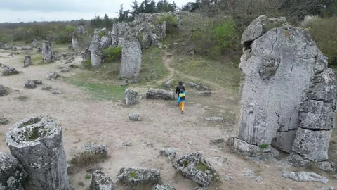 Two children walking through rocky landscape and limestone formations. Outdoor Stock Footage 324880052