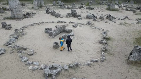 Two children walking through rocky landscape and limestone formations. Outdoor Stock Footage 324880338