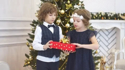 Two children of younger school age open the Christmas gift. Stock Footage 70782602