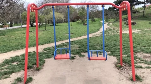 Two children's swing on the playground Stock Footage 106925881